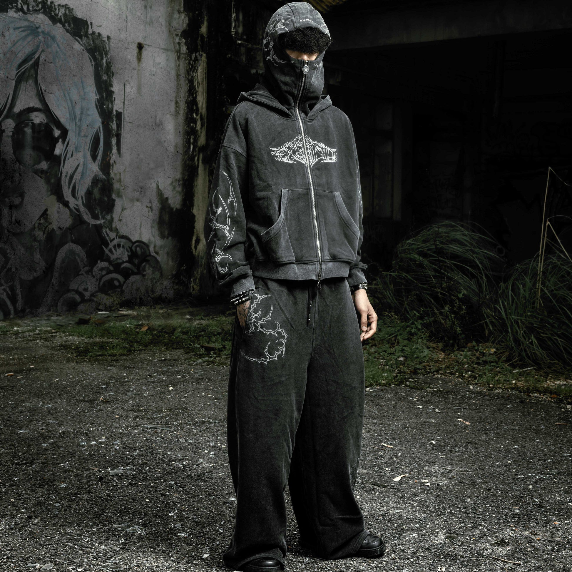 Oversized stonewashed black flared sweatpants and Shroud zip up hoodie oversized cropped embroidered tribal chest graphic embroidery tribal gothic graphic — EXPND